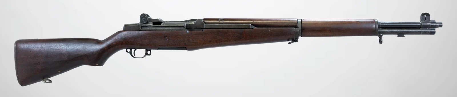 Full side-view museum photograph of an M1 Garand rifle on white.