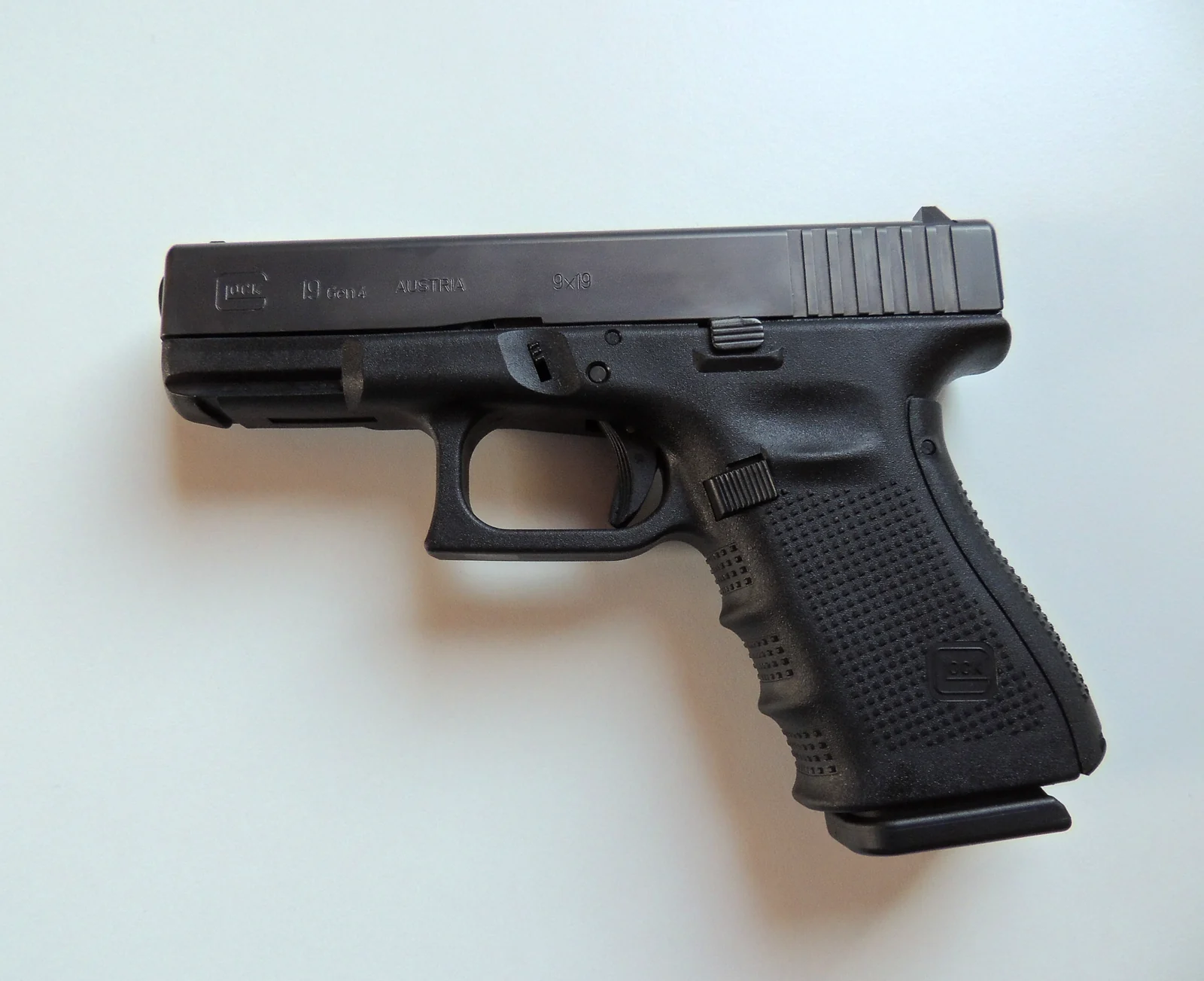 Left-side photograph of a black Glock 19 with visible Gen4 markings.